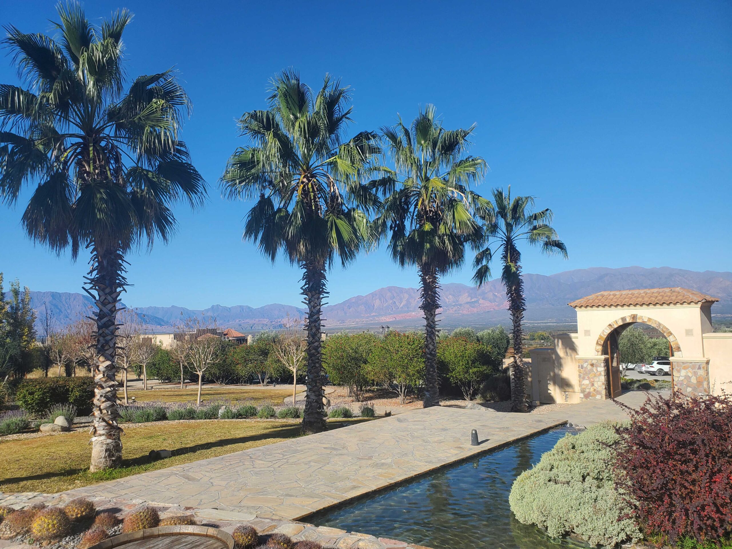 Entrance to Piattelli Bodega with spa and resort in background.