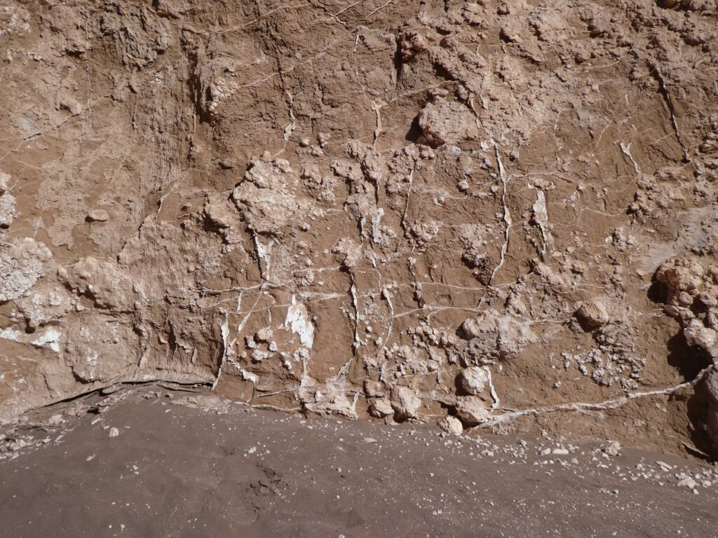 Salt cracks between rocks at the sand dunes at Valle de la Luna