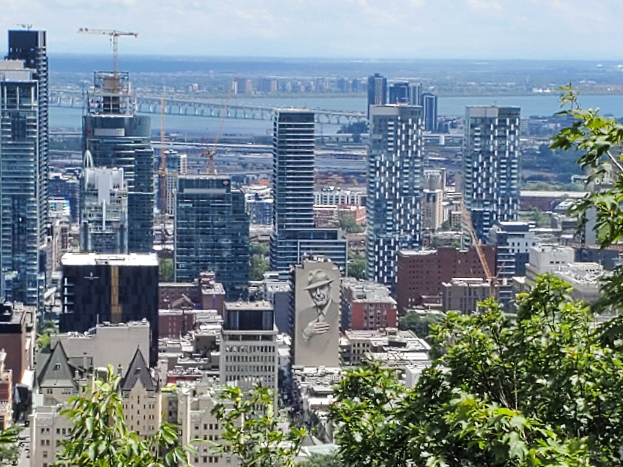 Montreal city skyline from Mont Royal featuring the mural portrait of Leonard Cohen