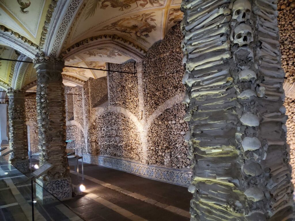 Supporting columns decorated with leg bones and skulls in the Chapel of the Bones in Évora, Portugal
