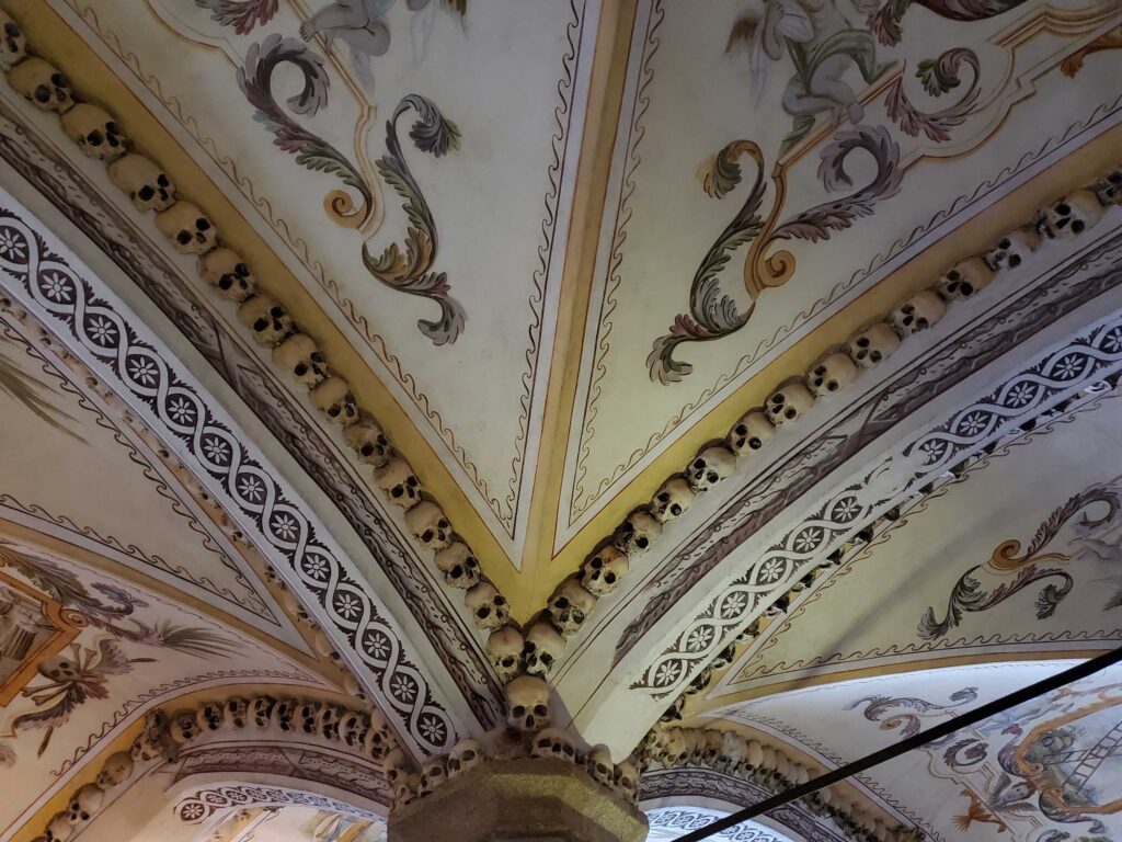 A stylish molding of monk skulls decorating the vaults of the ceiling in the Chapel of the Bones in Évora, Portugal